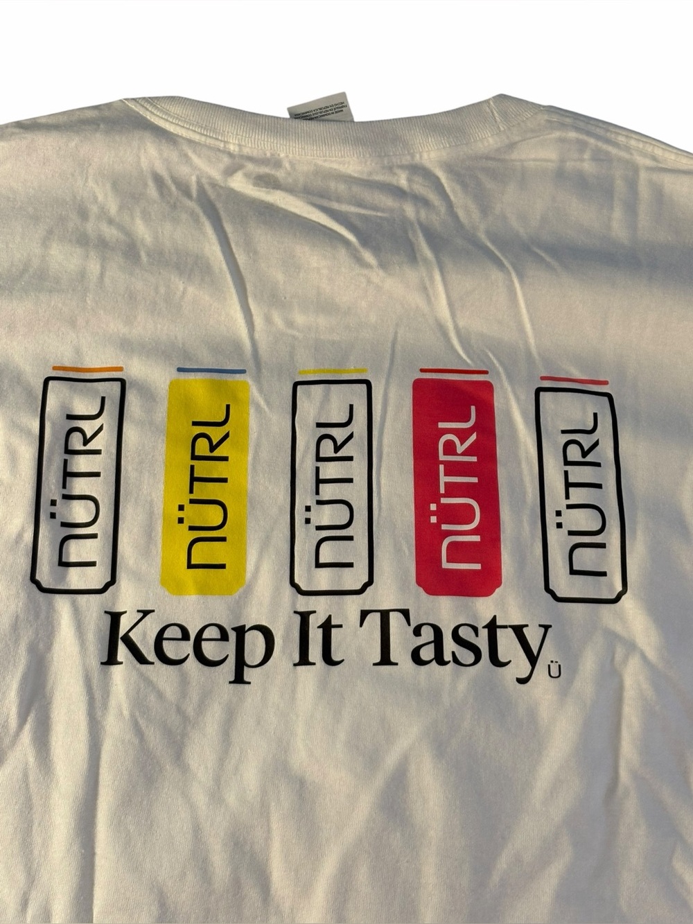 NÜTRL Keep It Tasty Graphic Tee - White with Yellow & Red Cans. Size XL. EUC